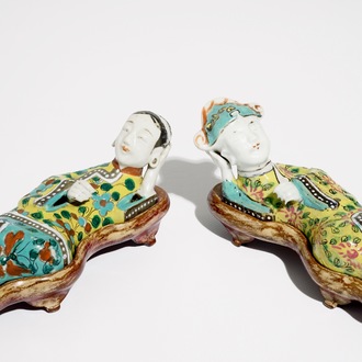 A pair of Chinese famille rose wall pocket vases shaped as resting figures, early 19th C.