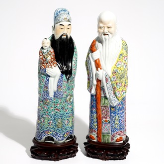 A pair of Chinese famille rose figures of immortals on wooden bases, 19/20th C.