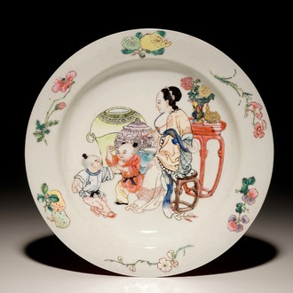 A Chinese famille rose ruby back eggshell plate with a lady and playing boys, Yongzheng