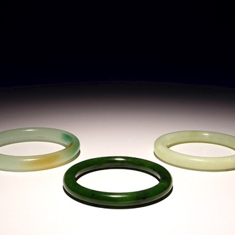 Three Chinese celadon and spinach green jade bangles, 19/20th C.