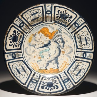 A rare Dutch Delft or Haarlem maiolica dish with a putto, 1st half 17th C.