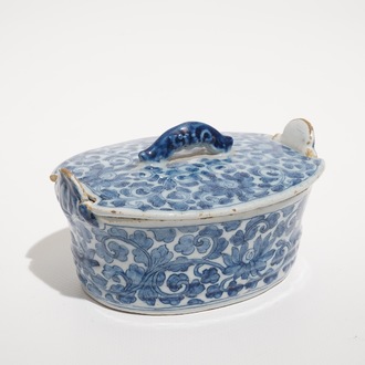 A Dutch Delft blue and white butter tub with chinoiserie design of peony scrolls, 18th C.