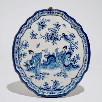 A Dutch Delft blue and white chinoiserie plaque with two ladies, 18th C.
