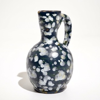 A French faience jug with blue ground "A la bougie" design, Nevers, 17th C.