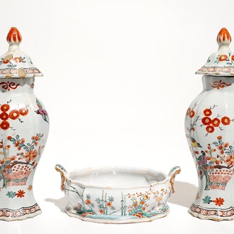 A pair of polychrome Dutch Delft petit feu Kakiemon style vases and a butter tub, 18th C.