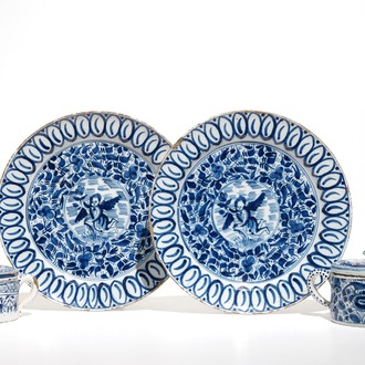 A pair of Dutch Delft blue and white dishes with cherubs and two sugar pots, 18th C.