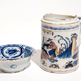 A Dutch Delft blue and white chinoiserie bowl and a polychrome Braunschweig mug, 1st half 18th C.