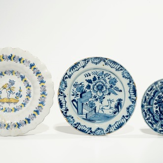 Three various Dutch Delft blue and white plates, incl. a gadrooned dish with a cherub, 17/18th C.