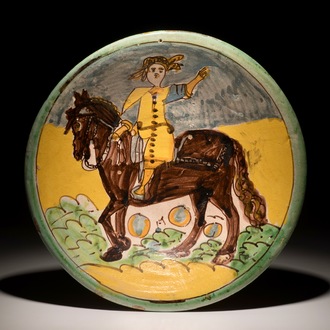 A polychrome Italian maiolica dish with a horserider, Montelupo, 17th C.