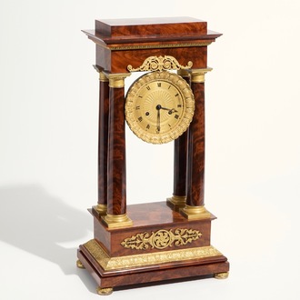 An Empire mahogany and gilt bronze portico mantle clock, France, 19th C.