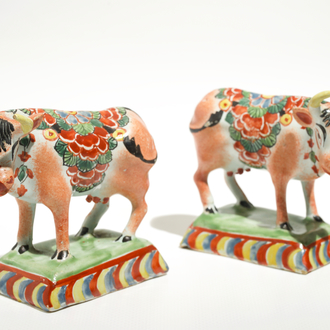 A pair of polychrome Dutch Delft petit feu cows on bases, 18th C.