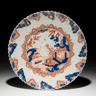 A fluted Dutch Delft doré chinoiserie dish with a pagoda in landscape, 18th C.