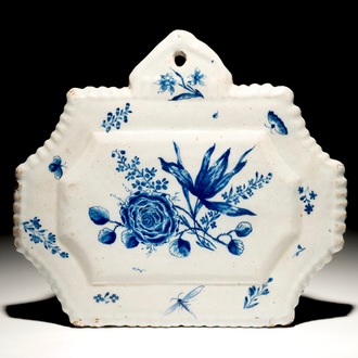 A Dutch Delft blue and white plaque with floral design, 18th C.