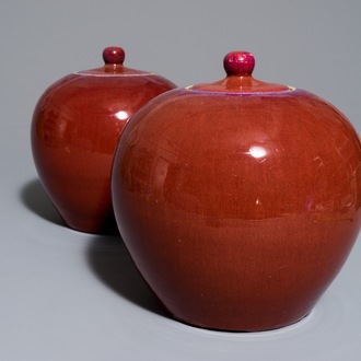 A pair of Chinese monochrome oxblood-glazed ginger jars and covers, 19th C.