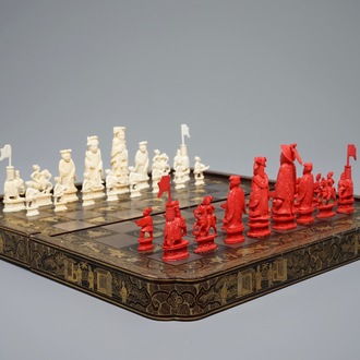 A Chinese lacquered chess and backgammon board with ivory chessmen, 19th C.