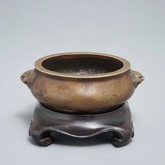 A Chinese bronze censer on wooden stand, Xuande mark, 18th C.