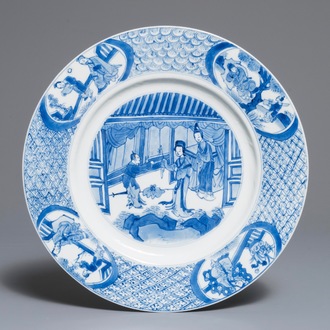 A Chinese blue and white dish with figures in an interior, Kangxi mark and of the period