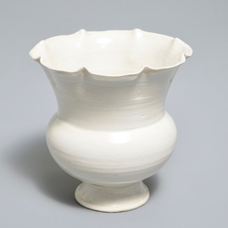 A Chinese foliate-rimmed cream-glazed dingyao bowl on foot, Song or later