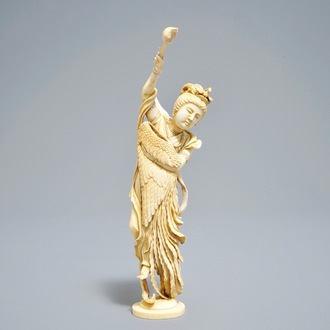 A Japanese ivory okimono of the goddess Kannon holding a fenghuang wing, signed, Meiji, 19th C.