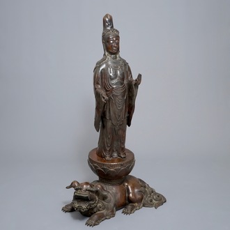 A large Japanese bronze group of Kannon on a Shi-shi, Meiji, 19th C.