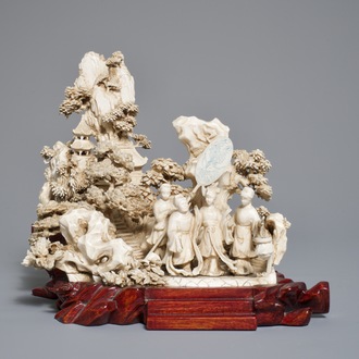 A Chinese ivory group of figures in a landscape on carved wooden base, 1st half 20th C.