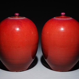 A pair of Chinese egg-shaped monochrome oxblood-glazed jars and covers, 19th C.