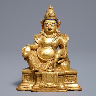 A Sino-Tibetan gilt bronze figure of Jambhala, 19/20th C.