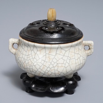 A Chinese ge-type crackle-glazed tripod censer and cover on stand, 19/20th