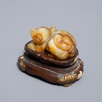 A Chinese celadon and russet jade carving of a tiger, Ming