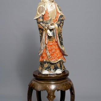 A large Japanese Satsuma figure of Kannon on laquered wooden stand, Meiji, 19/20th C.