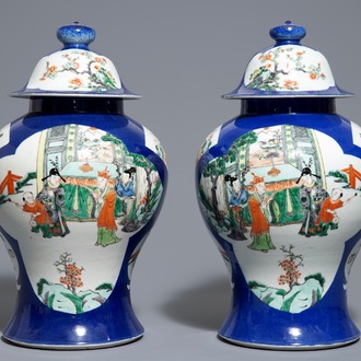 A pair of Chinese famille verte blue ground vases and covers, 19th C.