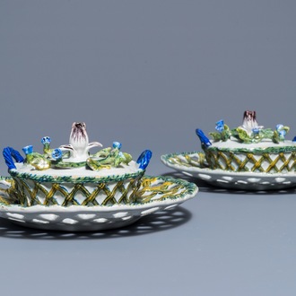 A pair of polychrome Dutch Delft butter tubs with applied design on reticulated stands, 18th C.