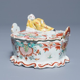 A polychrome Dutch Delft petit feu and doré butter tub with a reclining Chinaman, 18th C.