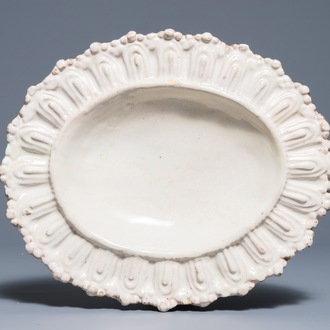 An Italian maiolica gadrooned oval monochrome white dish, Faenza, 17th C.