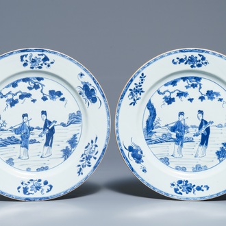 A pair of Chinese blue and white dishes with ladies in a garden, Yongzheng/Qianlong