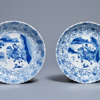 A pair of Chinese blue and white 'Mongolian hunting scene' plates, Chenghua marks, Kangxi