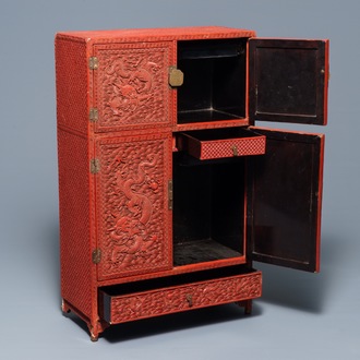 A Chinese cinnabar 'dragons and phoenixes' lacquer cabinet, 19th C.