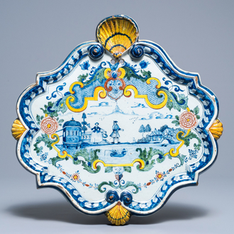 A large polcyhrome Dutch Delft plaque with a couple near a river, 18th C.