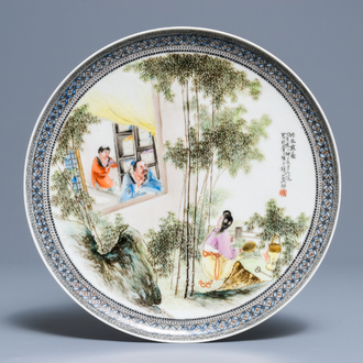 Une assiette en porcelaine de Chine fencai à décor de figures dans un jardin, République, 20ème