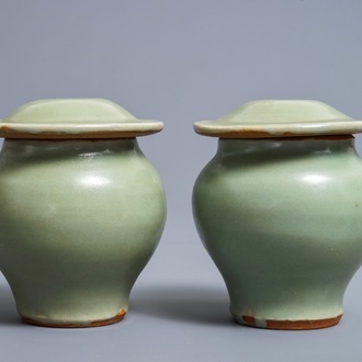 A pair of Chinese Longquan celadon vases and covers, Ming
