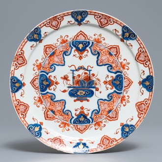 A Dutch Delft doré Imari-style plate with a flower basket, 18th C.