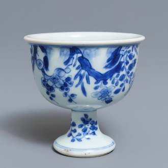 A Chinese blue and white stem cup with birds among blossoms, Transitional period