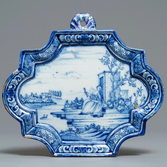 A Dutch Delft blue and white plaque with a lady in a landscape, 18th C.