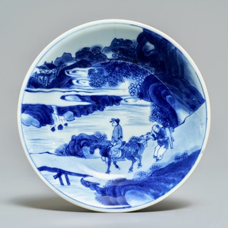 A Chinese blue and white plate with travellers in a landscape, Kangxi mark and of the period