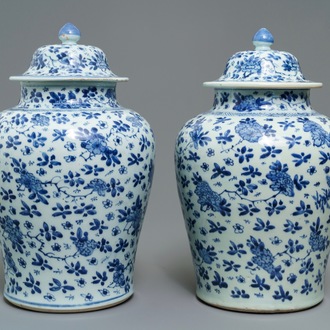 A pair of Chinese blue and white covered vases with floral design, Kangxi