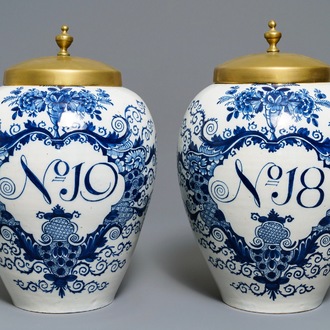 A pair of large Dutch Delft blue and white tobacco jars with brass covers, 18th C.