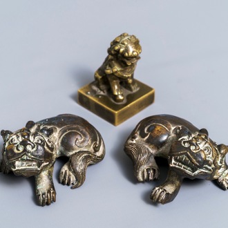 A pair of Chinese bronze 'lion' scroll weights and a seal, Ming and 18th C.