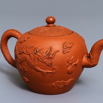 A Chinese Yixing stoneware teapot with applied dragons, Kangxi