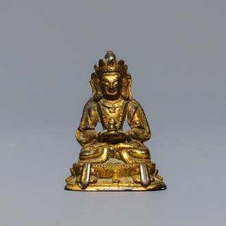 A Sino-Tibetan gilt bronze miniature figure of Buddha, 16/17th C.