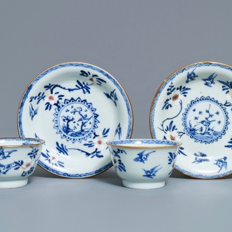 A pair of Chinese blue, white and underglaze red cups and saucers, Kangxi